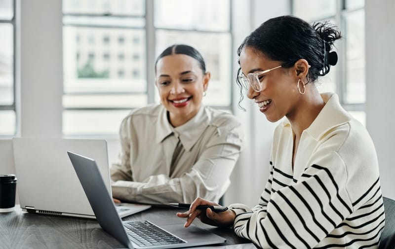 two colleagues at their laptop