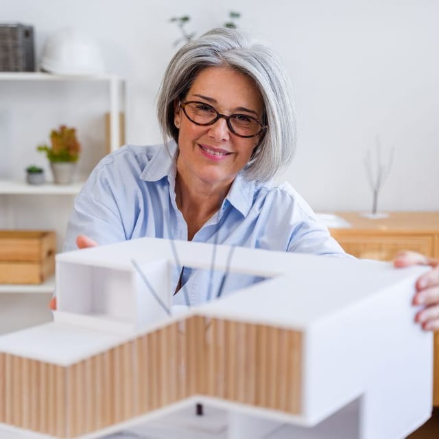 female architect with mordern house model