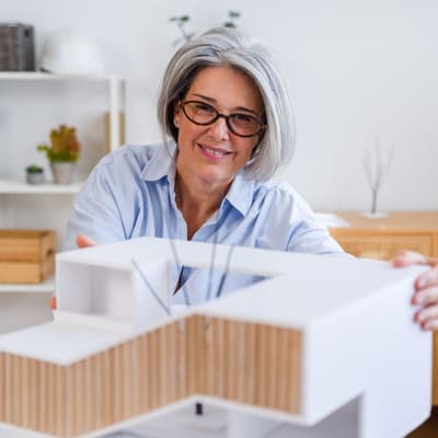 Architect with a model of a modern house